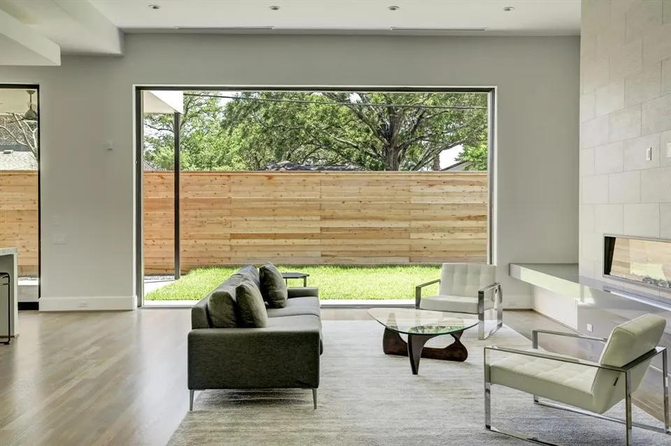 Living room opening through sliding glass to the garden